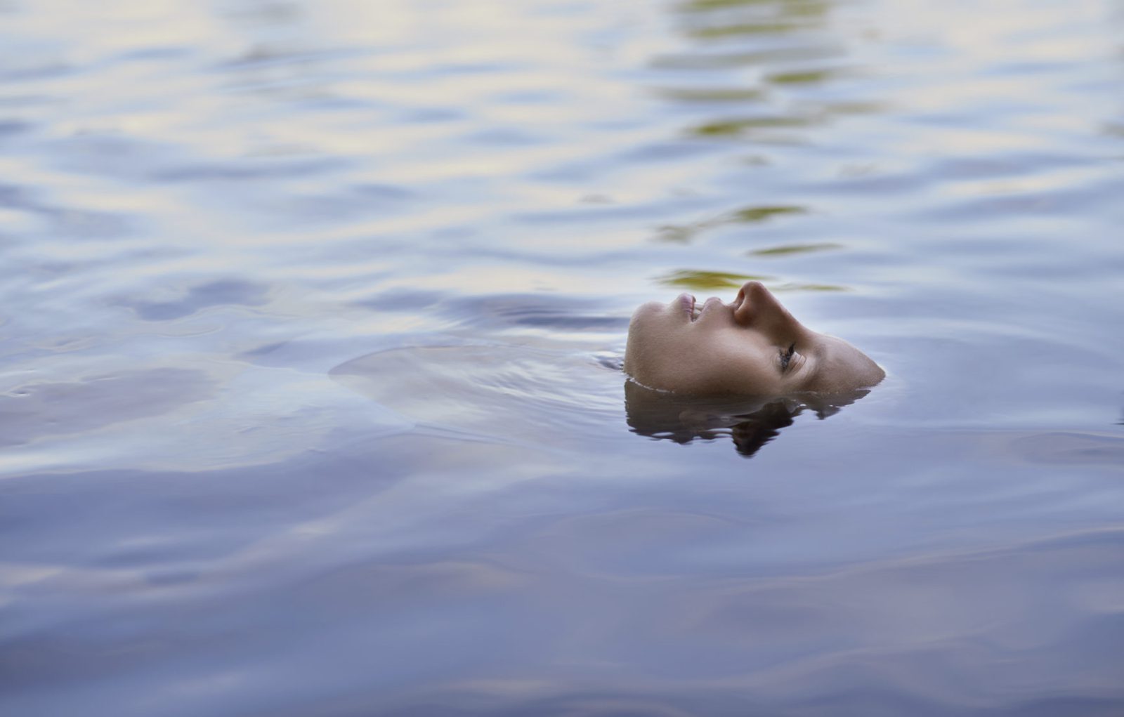 Conceptual image of a woman's face in rippled water